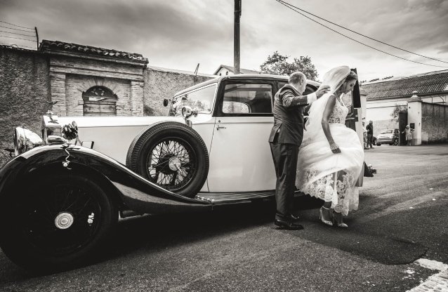 bride exits an old car